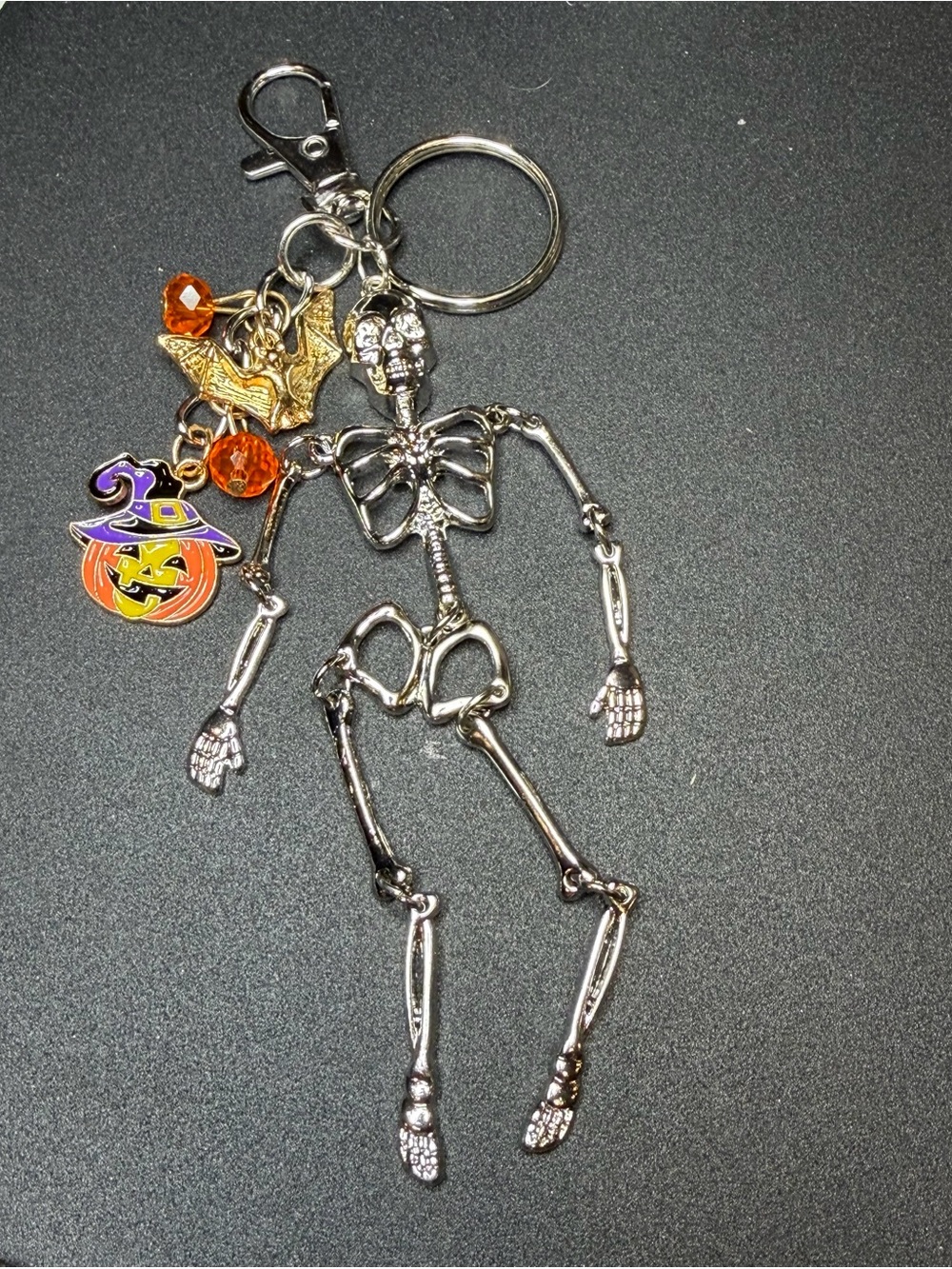 Festive Silver Skeleton Keychain with Orange Pumpkin Charm